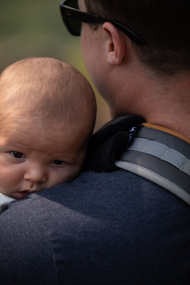 dad carrying baby with lifehandle